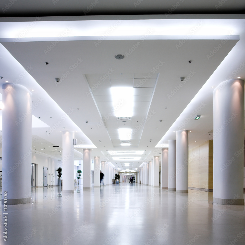 Fototapeta premium White hall of office centre, people move