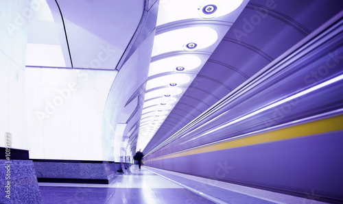 Violet train on platform in subway