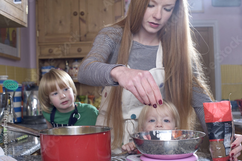 young family cooking in the kitchin photo