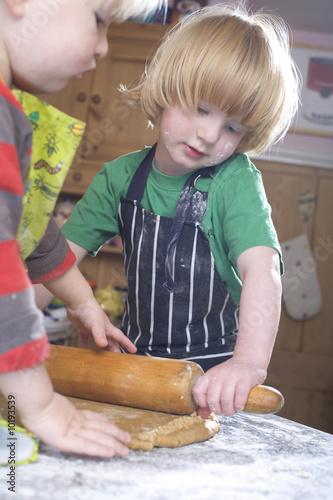 young family cooking in the kitchin photo