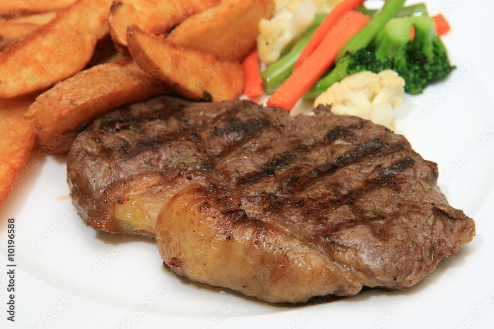 Sirloin steak with potato wedges and vegetables