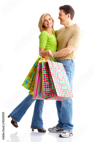 Shopping smile couple. Isolated over white background.