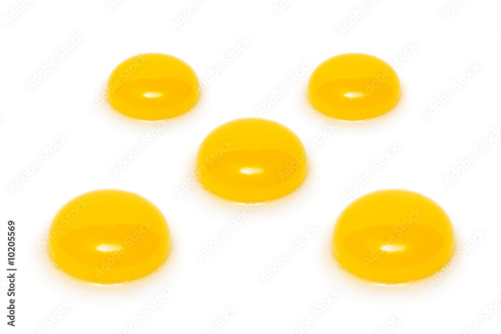 Close up of five yolks isolated on white background. Close up of five yolks isolated on white background.