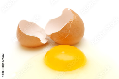 Broken egg over white background.