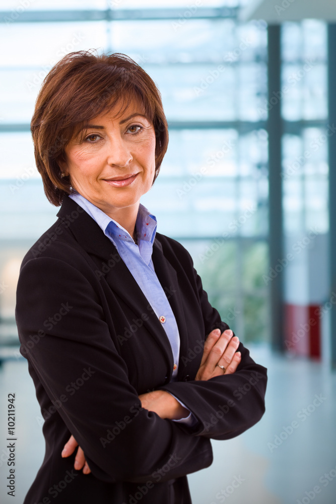 Portrait of senior businesswoman at office lobby. Portrait of senior businesswoman at office lobby.