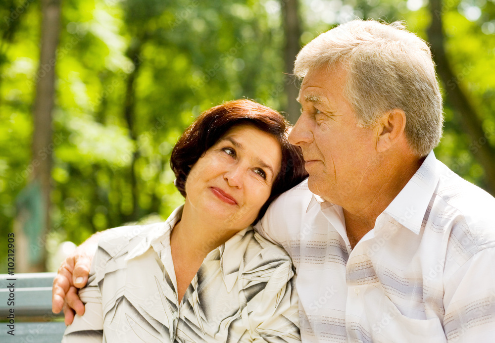 Happy senior couple embracing outdoors. Focus on man. Happy senior couple embracing outdoors. Focus on man.