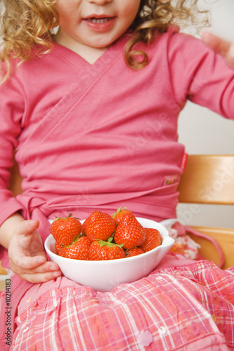 child with strawberries