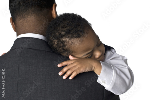 Portrait of an African American father holding his sleeping son