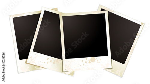 Collection of four blank polaroid photographs fanned out
