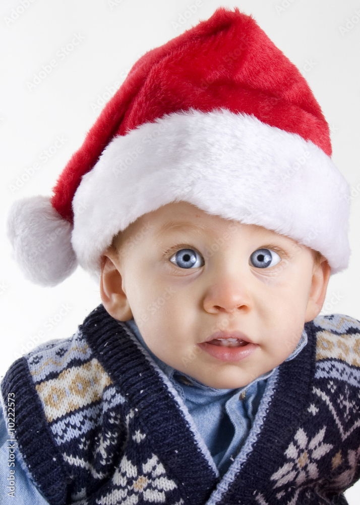Handsome young child wearing a red santa claus hat Handsome young child wearing a red santa claus hat
