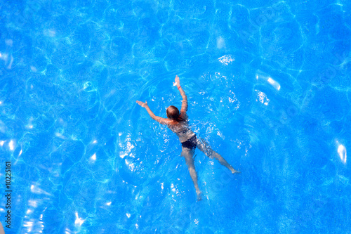 Blue water in the pool and girl.