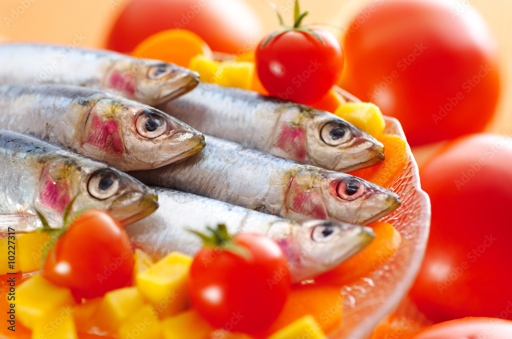 Group of sardines on different vegetables Group of sardines on different vegetables