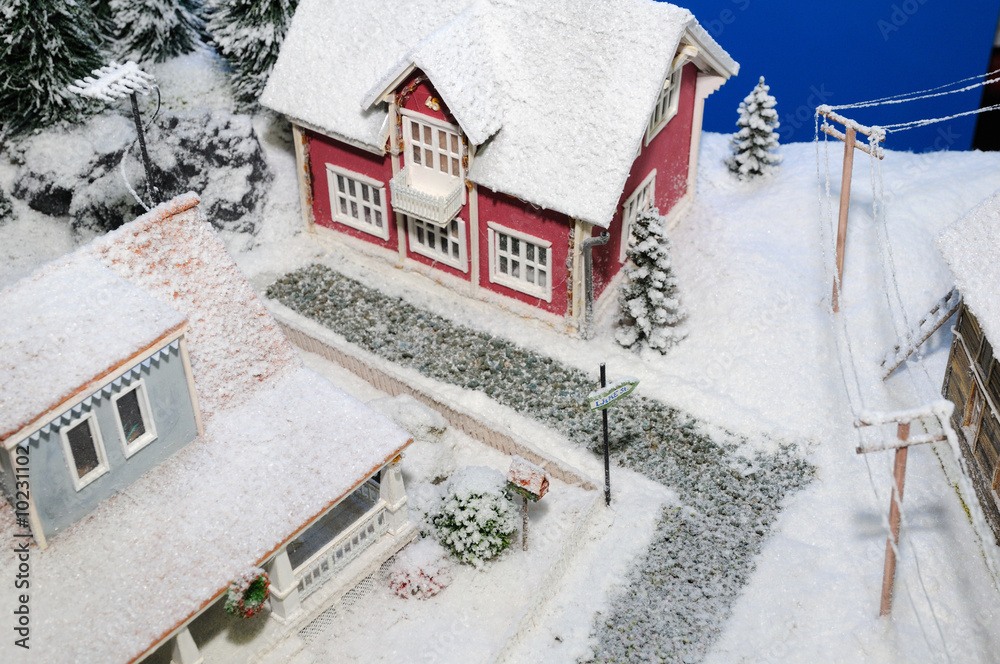 model of rural house covered by artificial snow