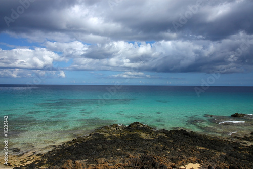 Coral-reef ,clean water and clouds on the sky