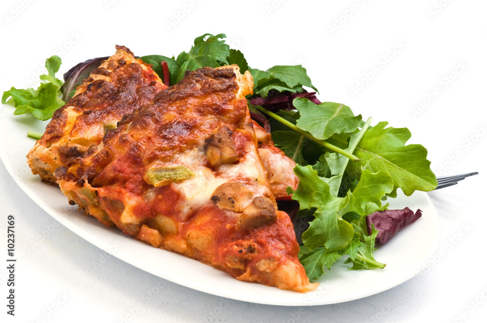 Delicious homemade pizza served with mixed greens.
