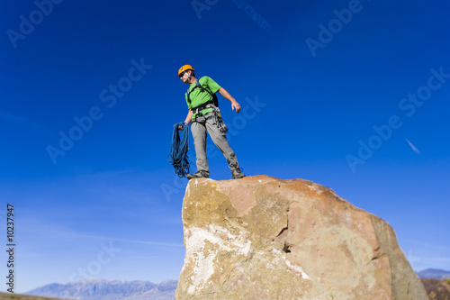 Climber on the summit of a rock spire.