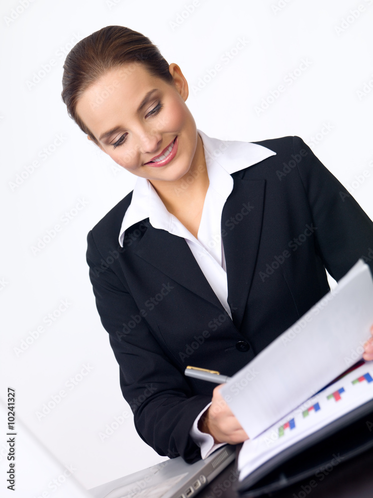Beautiful and young business woman working at the desk Beautiful and young business woman working at the desk