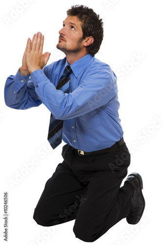 young Business man on his knees praying