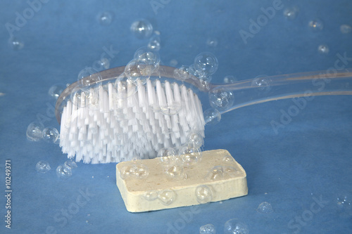 bath brush and soap covered in bubbles photo