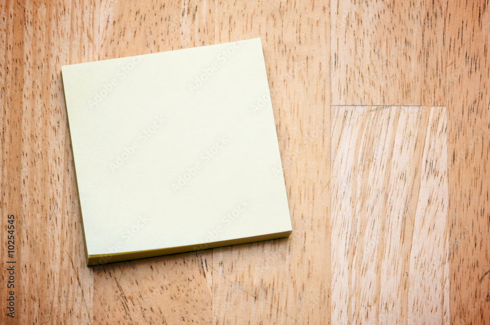 Post It Note Pad on a Wood Background Post It Note Pad on a Wood Background