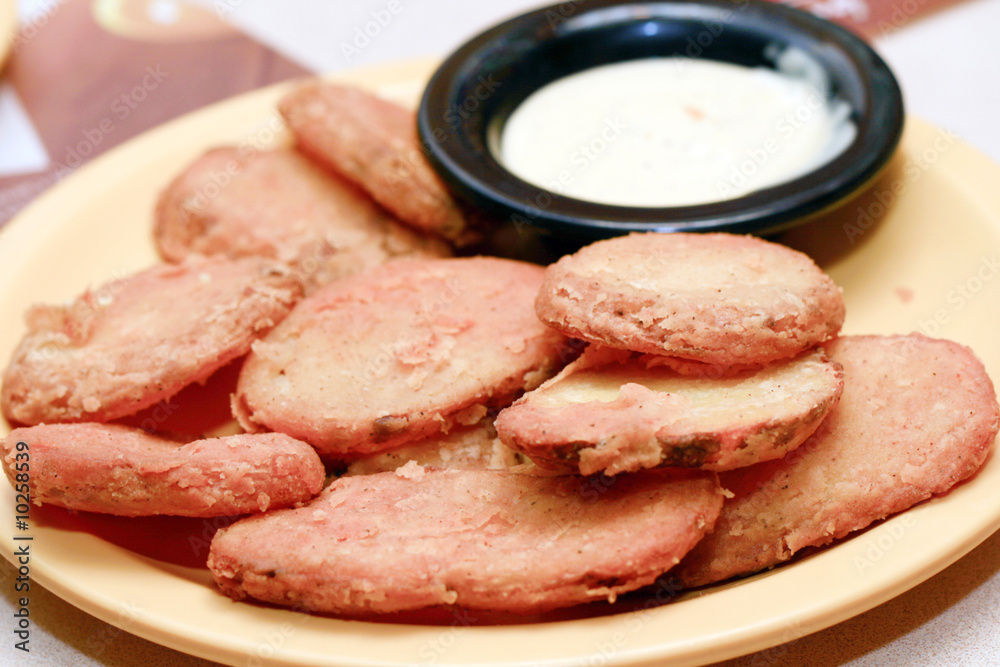 potato appetizers served with garlic flavored dip. potato appetizers served with garlic flavored dip.