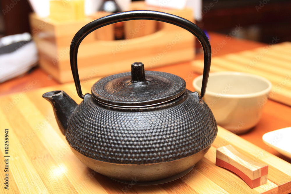 Yhe cast-iron teapot in a restaurant for green tea