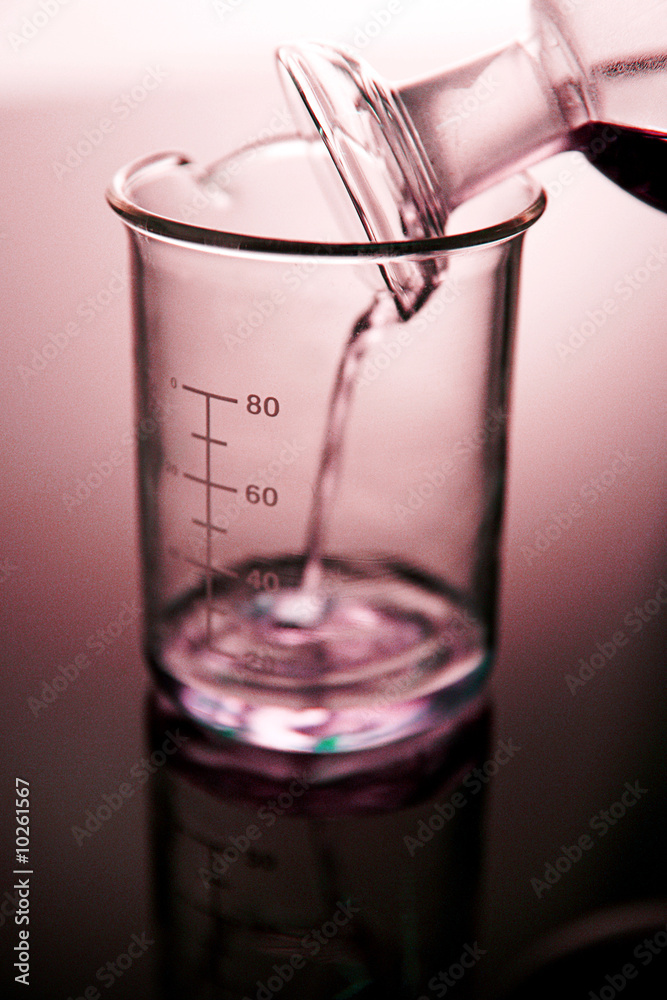Liquid being poured into lab beaker Liquid being poured into lab beaker