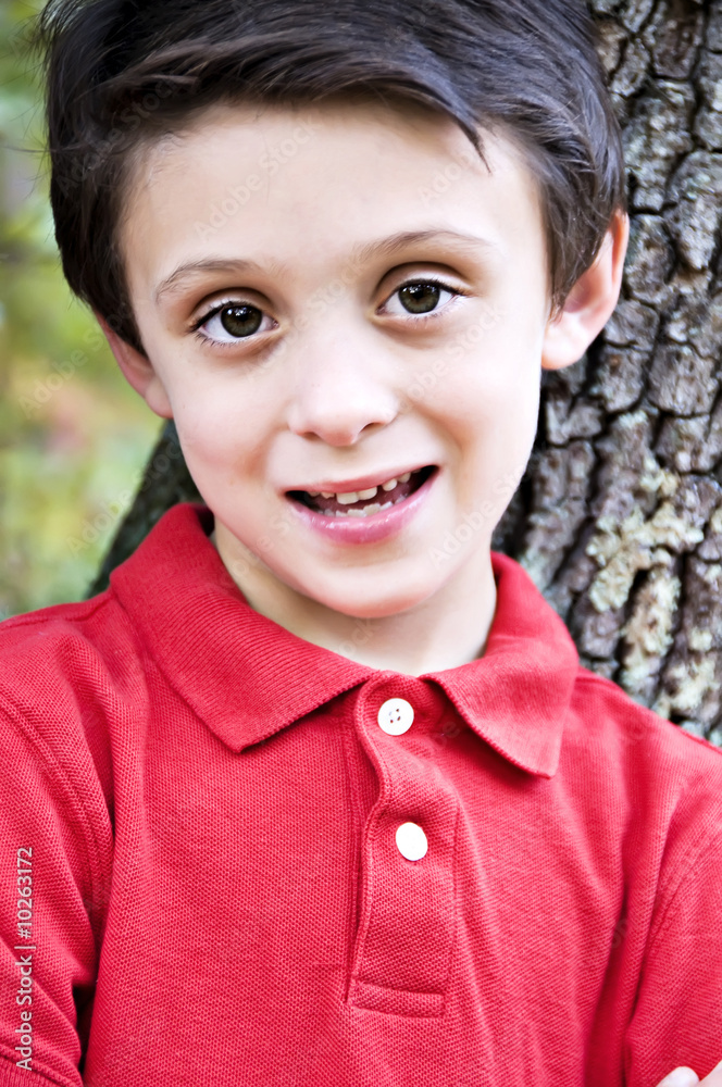 Brunette boy Close-up smiling showing his baby teeth Brunette boy Close-up smiling showing his baby teeth