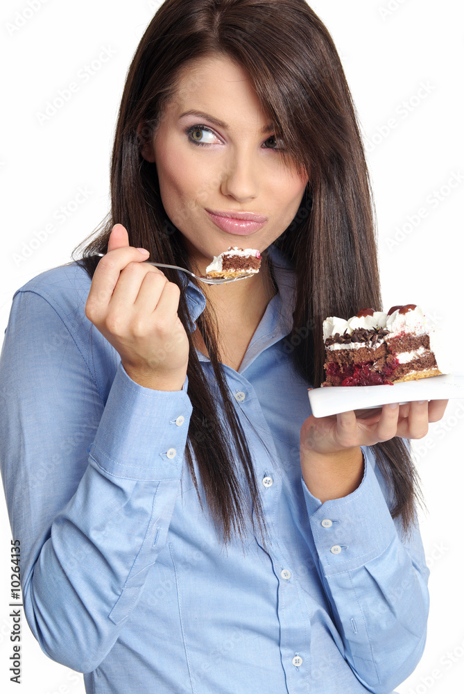 woman wearing blue shirt eating the cake. woman wearing blue shirt eating the cake.