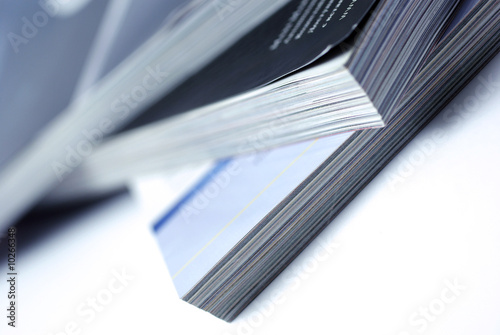 Stacked magazines isolated on white background.