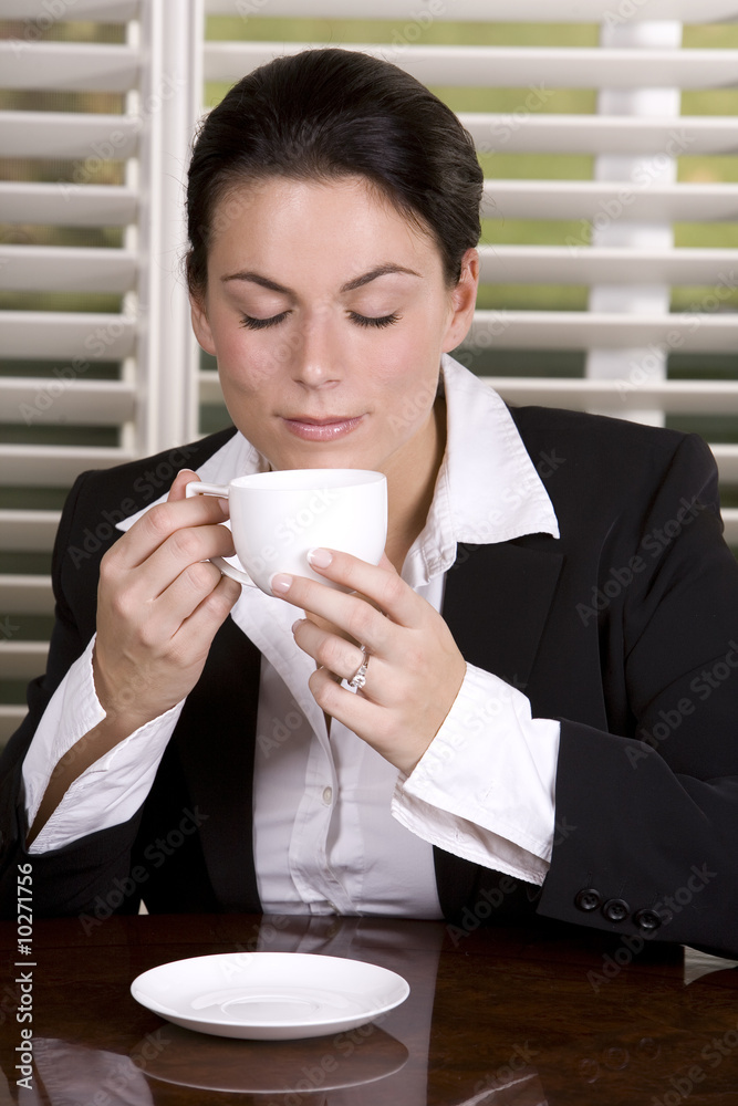 pretty business woman holding a cup of coffee pretty business woman holding a cup of coffee