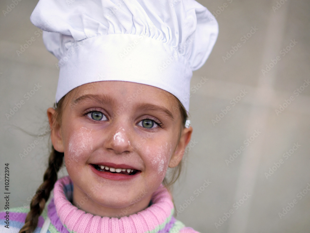 a young girl wearing a chef's hat a young girl wearing a chef's hat