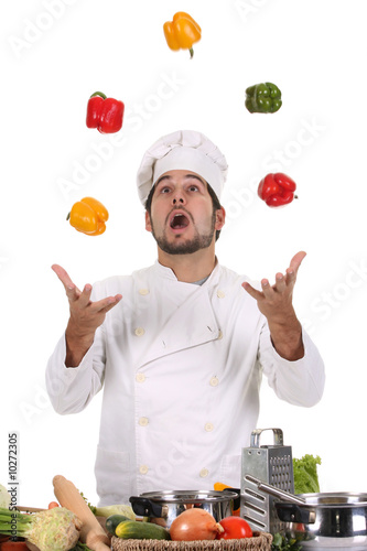 funny chef juggling with peppers in colors