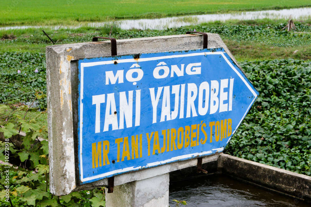 Sign in in Vietnam pointing to tomb of Tani Yajirobei. Sign in in Vietnam pointing to tomb of Tani Yajirobei.