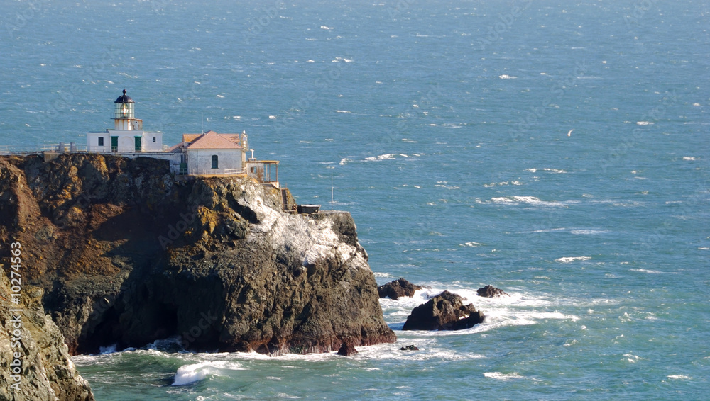 Lighthouse on a rocky coast overlooking the ocean