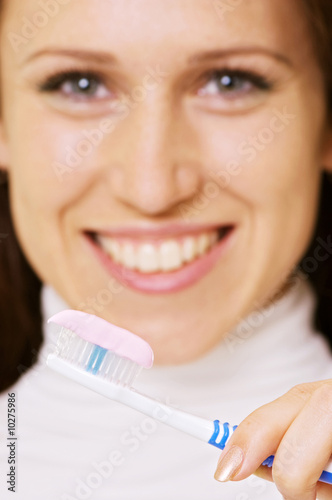 closeup portrait of smiley woman with toothbrush