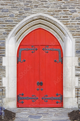Red church doors on a old stone church