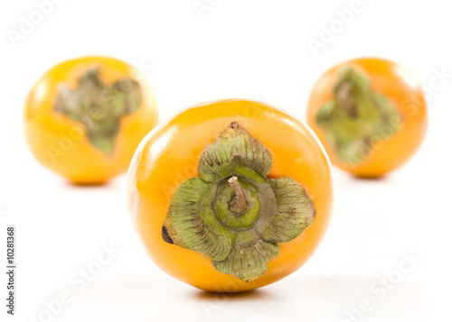 Fresh appetizing persimmon on a white background