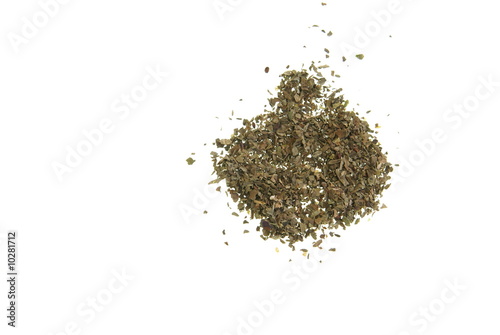 Dried Basil spread out on a white background