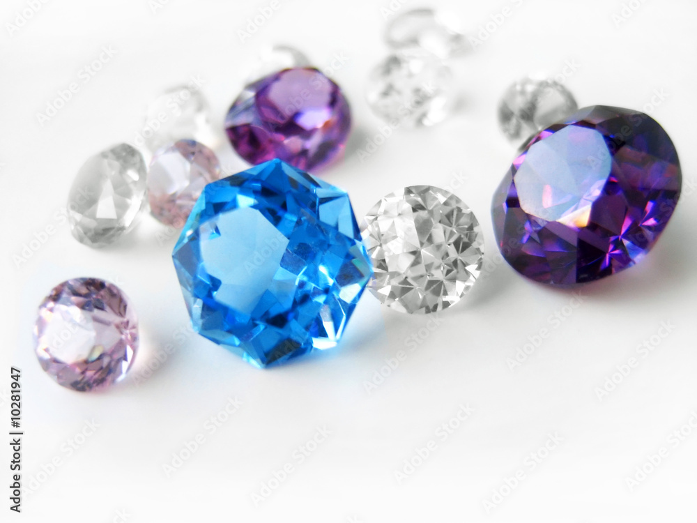 Blue & purple & colorless gems on white background Blue & purple & colorless gems on white background