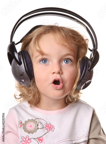 Child wearing headphone and listening the music