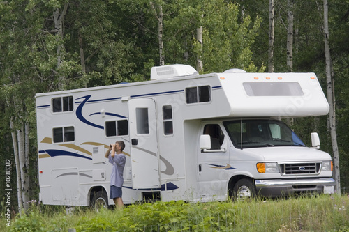 Big Motorhome with owner in the woods, Canada