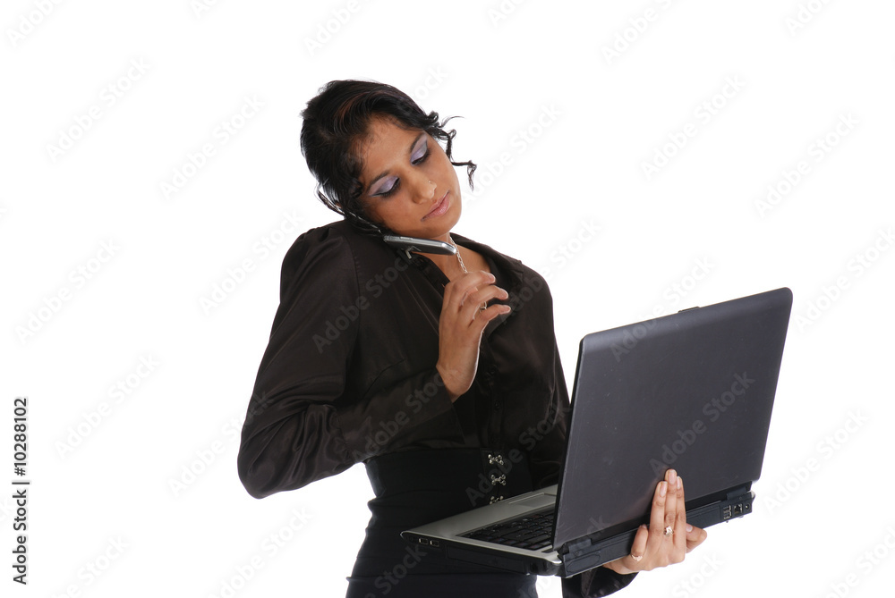 Picture of one girl working with laptop and cell phone Picture of one girl working with laptop and cell phone