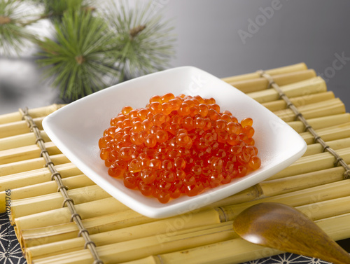 The fresh salmon roe on white plate