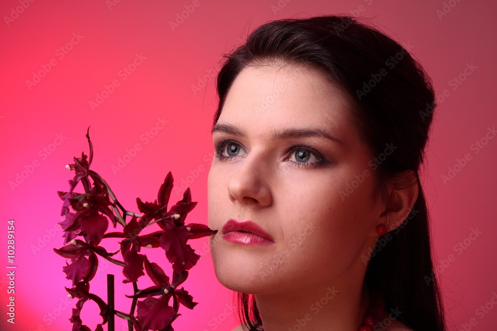 Fototapeta premium Young fashion model in studio with orchid