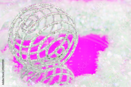 sparkly swirly christmas ball with reflection on pink
