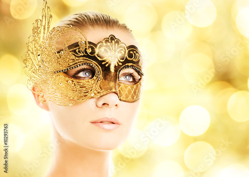 Beautiful young woman in carnival mask photo