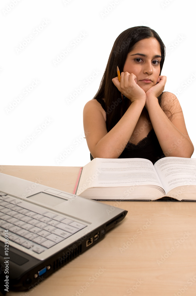 Young Hispanic woman sitting in front of desk Young Hispanic woman sitting in front of desk
