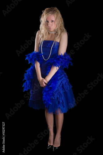 Beautiful girl in a dark blue dress and a pearl necklace