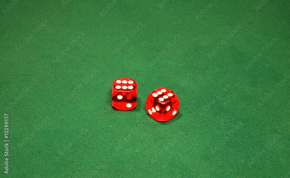 Two red dices on the green table in casino Two red dices on the green table in casino